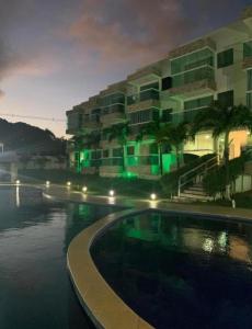 a building with a swimming pool in front of a building at apartamento em Jacumã in Jacumã