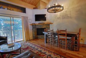 a living room with a table and a fireplace at Bed-N-Bliss in Kings Beach