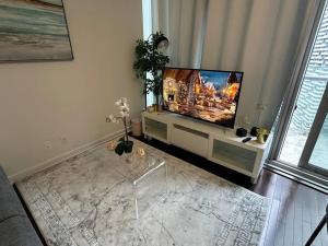 a living room with a flat screen tv on a stand at Downtown Toronto Luxury Condo in Toronto