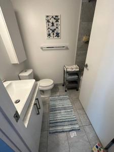 a white bathroom with a toilet and a sink at Downtown Toronto Luxury Condo in Toronto