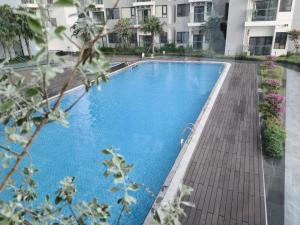 a swimming pool in front of a building at Ina apartment - Nera garden Hue in Hue