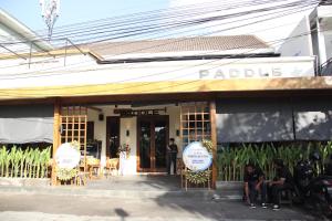a restaurant with people sitting outside of a building at ME Villas Echo Beach Canggu in Canggu