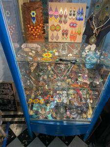 a glass display case filled with lots of different items at La Casa del K&eacute;ej Hostel in M&eacute;rida