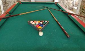 a pool table with balls and cues on it at SHEVABRAJOT in Pasto