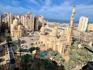 a large building with a mosque in a city at Cozy Flat near downtown Almorsi in Alexandria