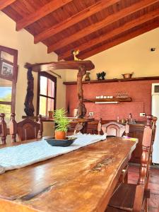 a kitchen with a large wooden table in a room at MIRADOR DE ESTRELLAS RESORT in Nono