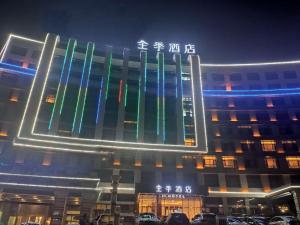 a building with colored lights on the front of it at Ji Hotel Zhangye West Station in Zhangye