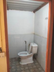 a bathroom with a white toilet in a room at Ratanakiri Lakeside Homestay & Tours in Banlung