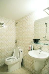 a bathroom with a toilet and a sink at Central entire house in Hanoi beer street in Hanoi