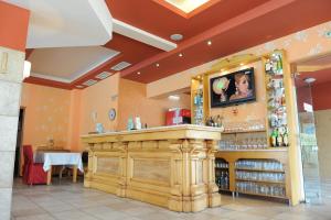 a bar in a restaurant with a counter at Hotel Racic Self-Check In in Voyvodinovo
