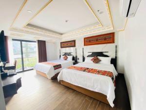Postel nebo postele na pokoji v ubytování Trung Huyền Hotel