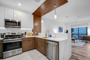 a kitchen with a sink and a stove top oven at Eminent Near EWR & NYC w/ Gym in Newark