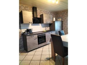 a kitchen with stainless steel appliances and a table at Holiday apartment Stephanie Ahlborn in Schönhagen