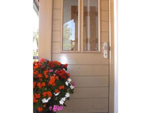 a door with a window and flowers next to it at Lovely apartment in Oberammergau in Oberammergau