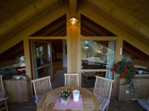 a wooden table and chairs on a porch at Lovely apartment in Oberammergau in Oberammergau