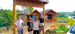 a group of people standing in front of a house at Đảo Chè Thanh Chương - Homestay Gió Lào in Trai Ðỏ