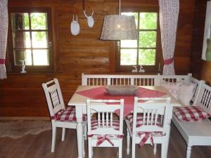 a dining room with a white table and chairs at Holiday home in Einberger Switzerland in Rödental