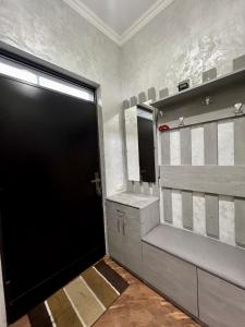a bathroom with a black door and a sink at New , comfortable 3 bedroom house in Yerevan