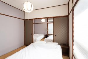Säng eller sängar i ett rum på Hakone No Yado