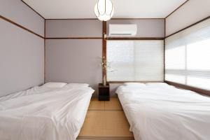 Un pat sau paturi într-o cameră la Hakone No Yado