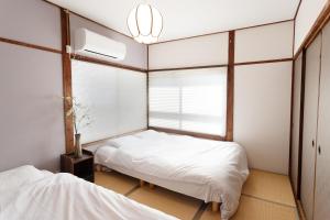 Un pat sau paturi într-o cameră la Hakone No Yado