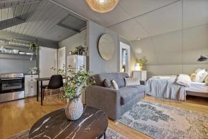 a living room with a couch and a bed at Venture Vacations-Cultural Gem in the Heart of Central Reykjavík in Reykjavík