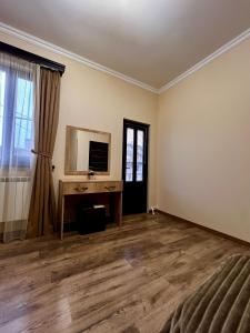 an empty living room with a desk and a window at New , comfortable 3 bedroom house in Yerevan