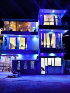 a building with blue lights on it at night at Yelagiri GoldHill Resort in Yelagiri