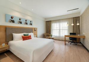 Ένα ή περισσότερα κρεβάτια σε δωμάτιο στο Greenpark Chennai +8 φωτογραφίες