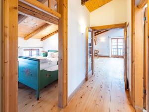 a bedroom with a bed and a wooden floor at Tateful apartment in Schliersee in Schliersee