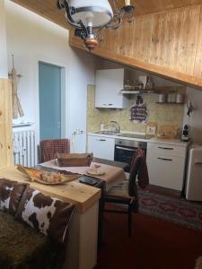 a kitchen with a table with a pizza on it at Monolocale Condominio Valleverde Fronte Piste in Sestriere