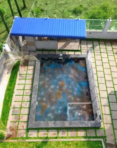 an overhead view of a swimming pool with a blue roof at Yelagiri GoldHill Resort in Yelagiri