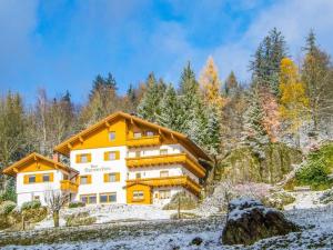 a house in the mountains with snow on the ground at Holiday apartment Sonnenfels II in Bodenmais