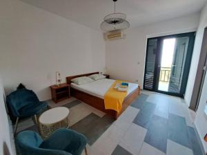 a bedroom with a bed and a table and chairs at Rooms Katja - 10 m from beach in Gradac