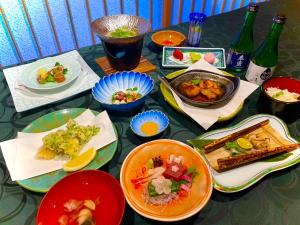 a table topped with plates of food and drinks at Sarusawaike Yoshidaya in Nara