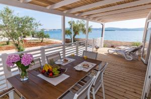 a wooden table with a bowl of fruit on a deck at San Antonio mobile homes in Biograd na Moru