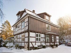 a house with snow on top of it at Cosy apartment in Harz in Schauenburg