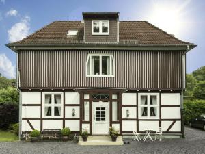 a large house with white and brown at Cosy apartment in Harz in Schauenburg
