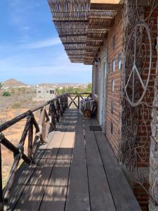 a wooden walkway on the side of a building at Baja69 lodge in El Pescadero