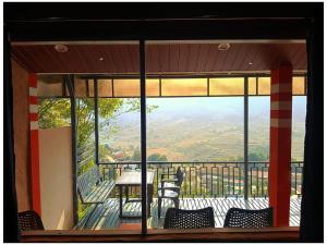 vista su un balcone con sedie e tavolo di Misty Mountains Holiday Homes a Vattavada