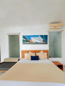 a bedroom with a large bed with two windows at Apple Villas & Apartments in Kerobokan