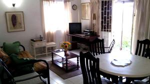 a living room with a table and a dining room at Morris Apartments in Saint James