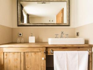a bathroom with a sink and a mirror at Lovely apartment in Schröcken in Schröcken +29 photos