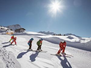 a group of people skiing down a snow covered slope at Lovely apartment in Schröcken in Schröcken