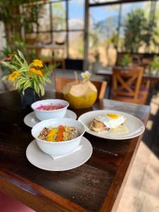 a table with three bowls of food on it at Sumberkima Hill Retreat 2 in Pemuteran