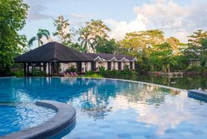 a swimming pool in front of a resort at Sheridan Boutique Resort Iloilo in Iloilo City