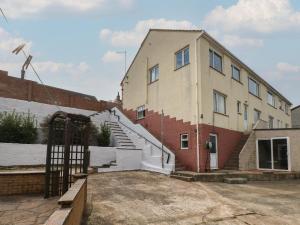 a building with a staircase in front of it at Murmur y Mor in Goodwick