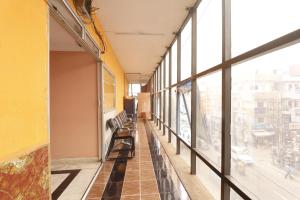 an empty hallway with benches in a building with windows at The Royal Comfort in Bangalore