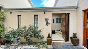 a door to a house with a bear on the wall at Sea-View Family Villa in Gordonʼs Bay