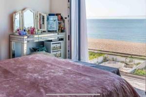 a bedroom with a bed and a view of the beach at 22 rooftop Penthouse ! in South Hayling